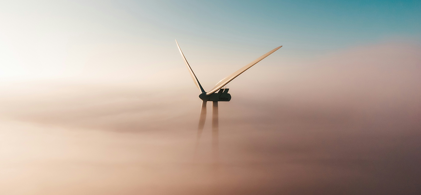 a wind turbine shrouded in mist.